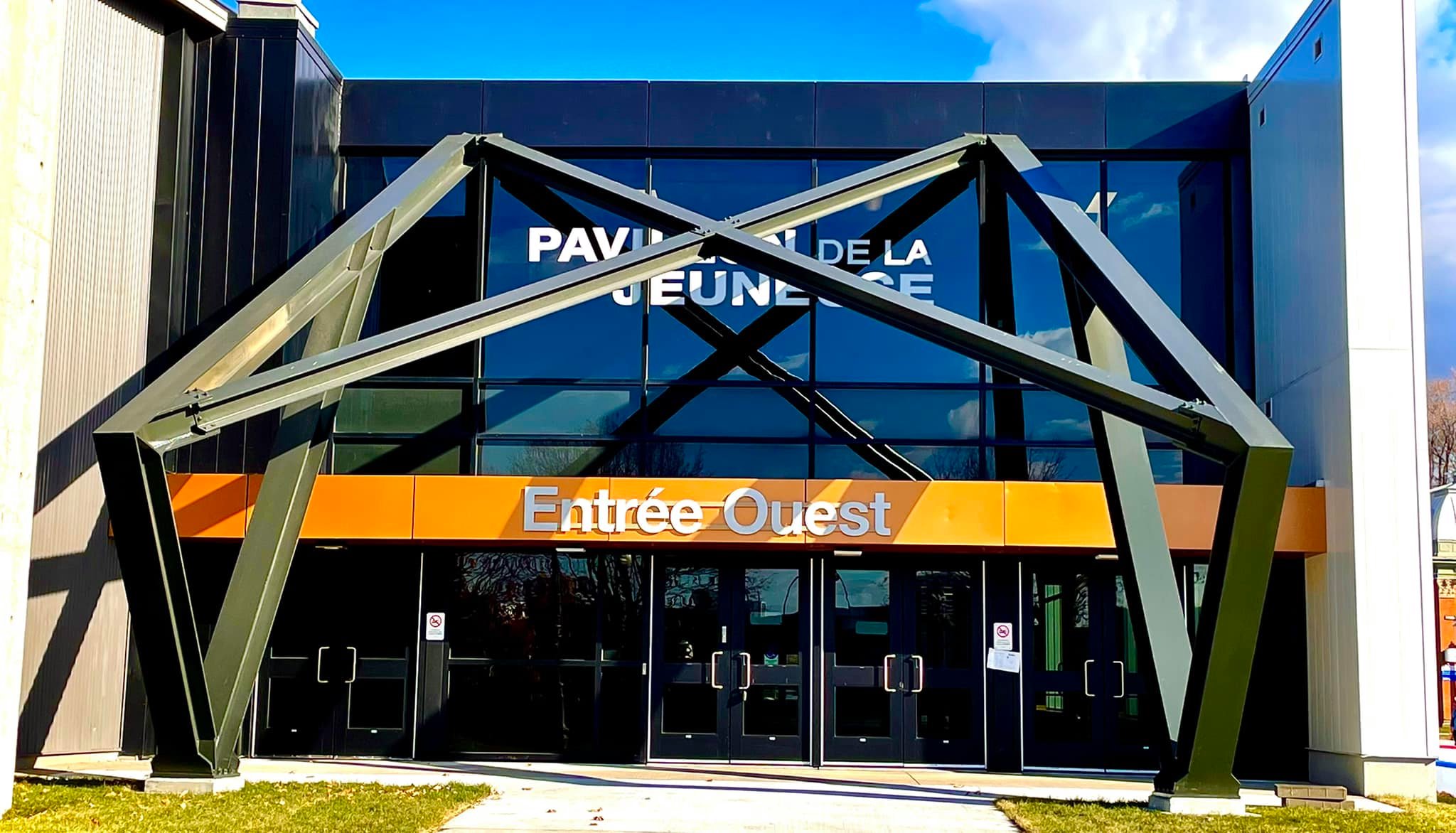 Façade vitrée d'un bâtiment avec structure d'entrée